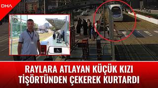 Raylara atlayan küçük kızı tişörtünden çekerek kurtardı