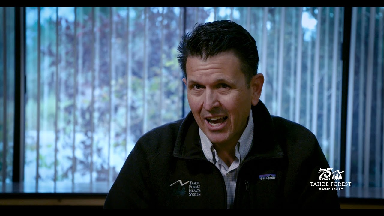 Brian Evans, Chief Medical Officer, sitting in front of a window