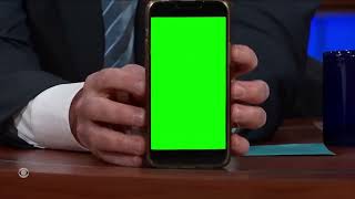 Stephen Colbert shows off a video on his phone green screen