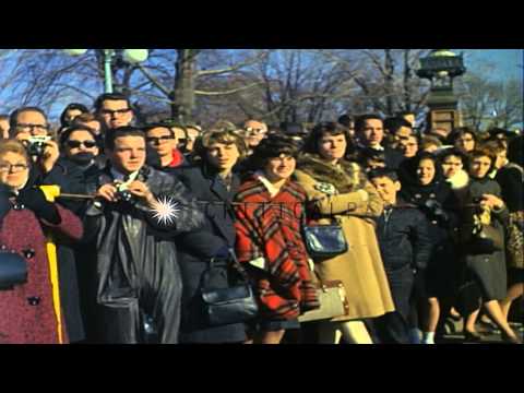 Crowd watch as the funeral procession of President John Kennedy leaves the Capito...HD Stock Footage