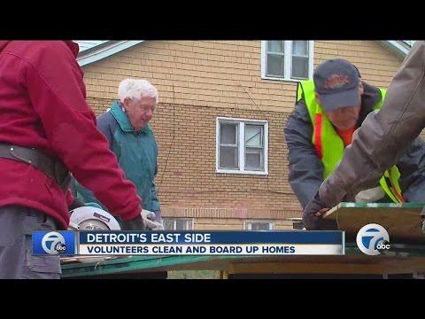 Volunteers board up and clean vacant homes in Detroit