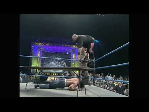 Mike Awesome pushes Bam Bam Bigelow through table