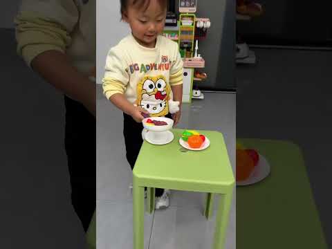 A cute little baby cooking for their mom!