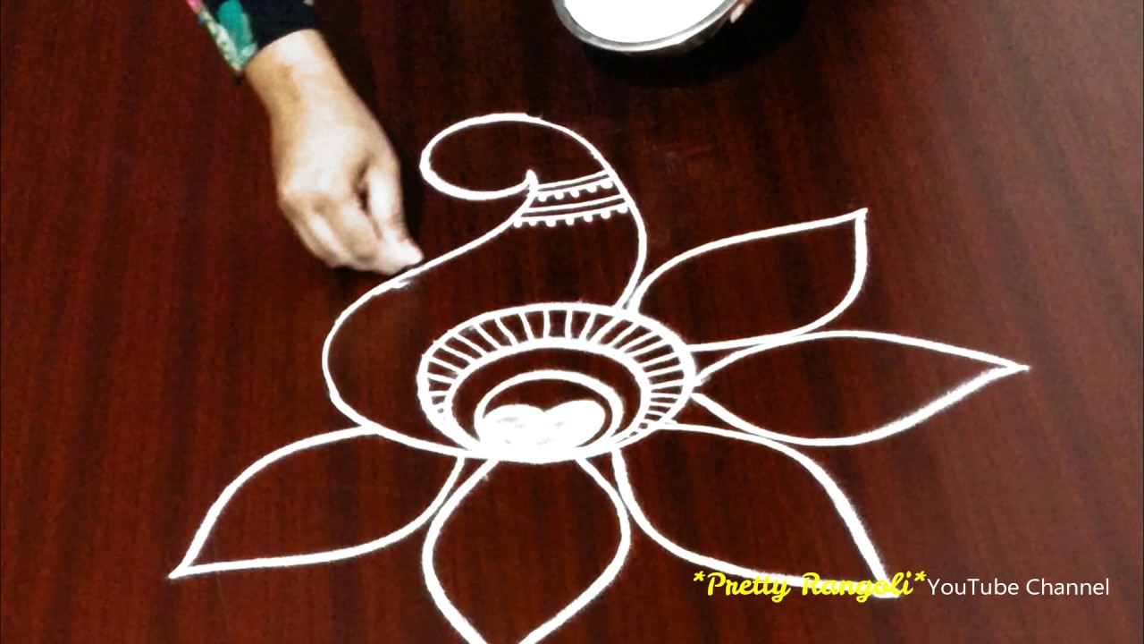 Attractive peacock rangoli design by pretty rangoli