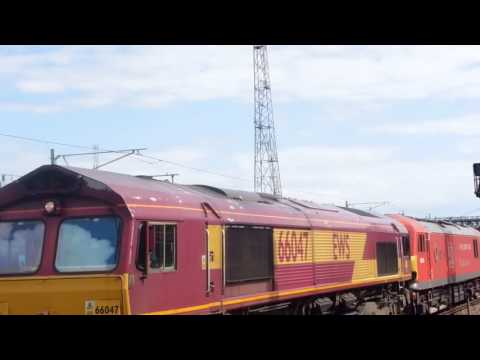 Class 66047 leads DB red 92015 through Ashford with unexpected tones.