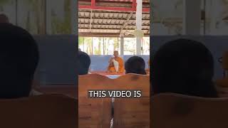 A cat is preventing a Buddhist monk from praying