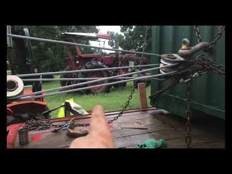 Part of a video titled How to Load a shipping container on a trailer - YouTube