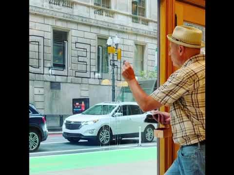 Robert W. Frese gilding a storefront window with 23K gold leaf. Downtown Chicago