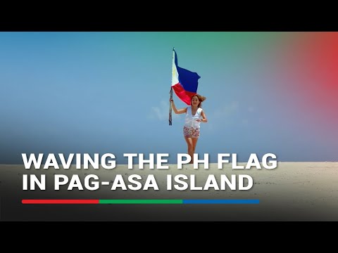 Filipino traveler waves Philippine flag in Pag-asa Island ABS-CBN News