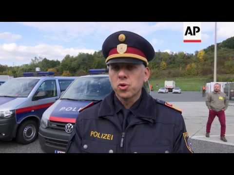 Migrants try to push through barrier near border