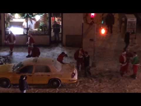 Roaming gang of drunken Santas stops for a brawl on NYC street corner