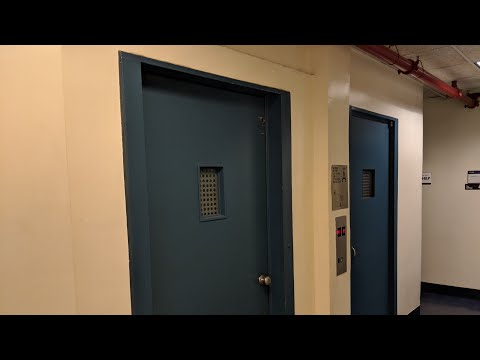Otis (modernized) swing door traction elevators in downtown Manhattan NYC New York