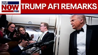 President Trump speaks to reporters aboard AF1