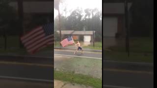 Florida Man waves American Flag during Hurricane Matthew