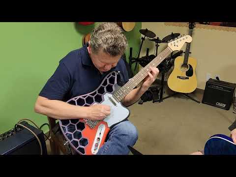 3d printed guitar. Mike Smith testing it.
