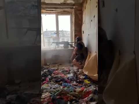 Ukrainian soldier firing from a 12.7 mm heavy machine gun NSV "Utes"