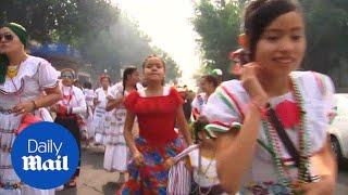 Guns blaze and paraders dance on Cinco de Mayo in Mexico City - Daily Mail