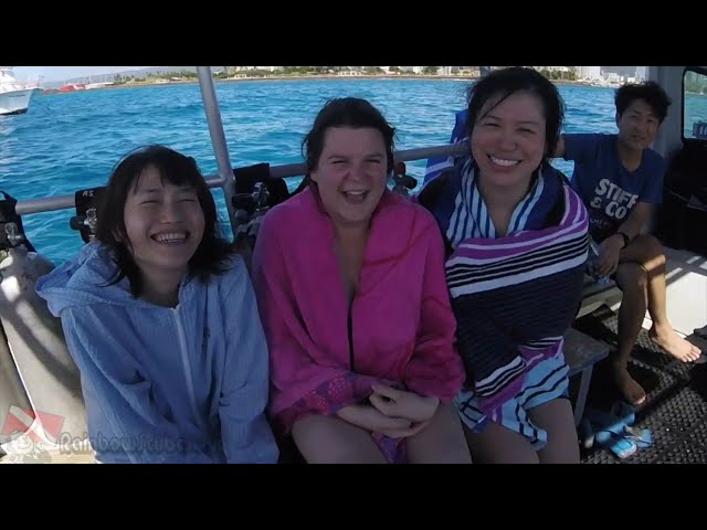A first-time scuba diver splashes into the clear blue water off Honolulu, Hawaii.