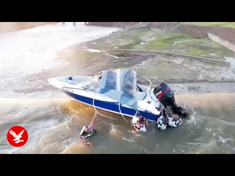 Dramatic moment boaters on dam rescued from edge of 130ft drop