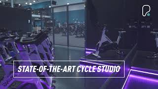 PureGym Exeter Bishops Court: Functional training area with resistance machines, turf, free weights, and mirrors along walls.