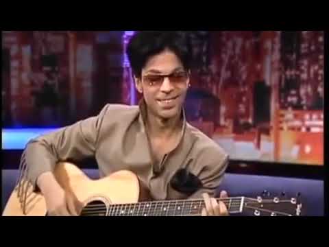 Prince playing acoustic guitar