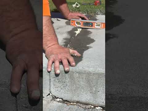 A close up look at lifting and leveling a sidewalk