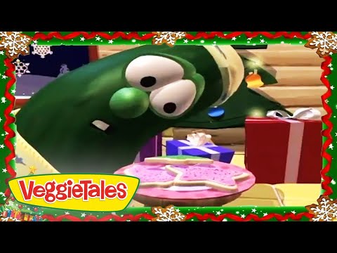 Larry the Cucumber from VeggieTales leans toward a pink birthday cake with presents nearby, inside a festive holiday border with the VeggieTales logo.