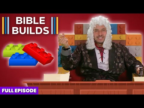 Host wearing a white powdered wig sits at a wooden desk in front of a colorful Lego brick backdrop; thumbnail for a video titled 'Bible Builds'