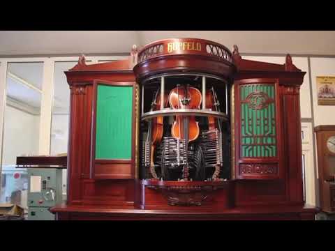 100 years old mechanical machine that plays three violins at the same time