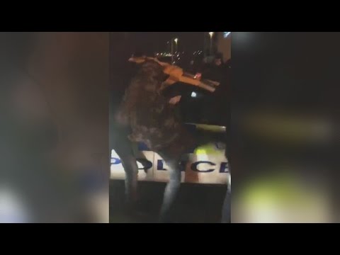 Masked men attack police car during protest over fatal shooting on M62