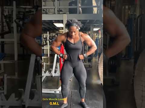 Muscle Female Bodybuilder Flexing at the GYM