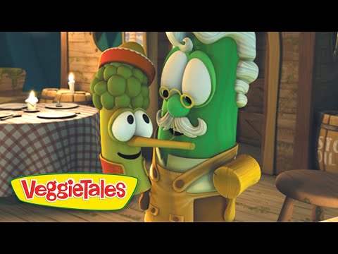 Two VeggieTales characters, a corn cob and a green vegetable with a mustache and glasses, kiss in a rustic kitchen, with the VeggieTales logo in the corner.