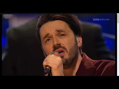 Roddy Hart performs Tinseltown In The Rain at Celtic Connections 2024 with the RSC