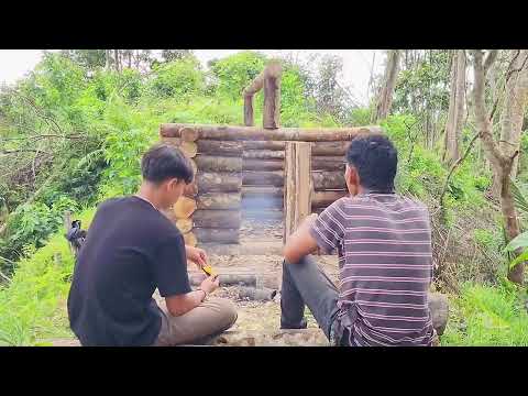 Two young men built a 5-square-meter mini shelter on the top of Mountain for camping. 