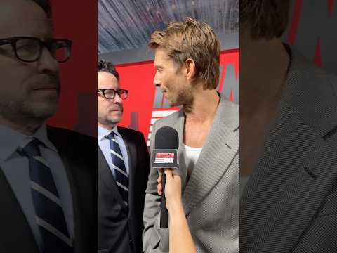 JJ Abrams surprises Glen Powell on The Running Man red carpet.