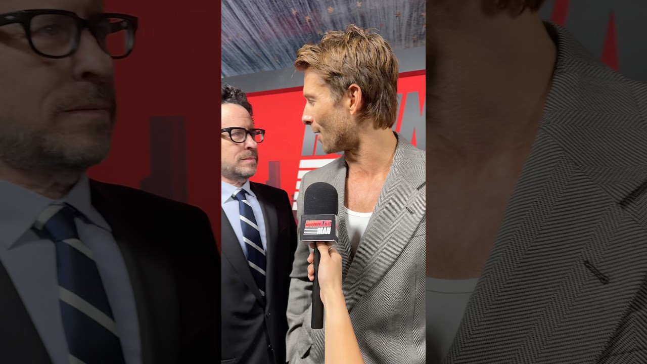 JJ Abrams surprises Glen Powell on The Running Man red carpet.