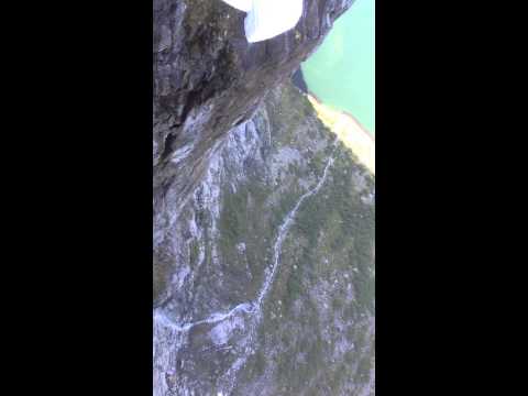 Basejumpers jumping off the cliff from Kjerag
