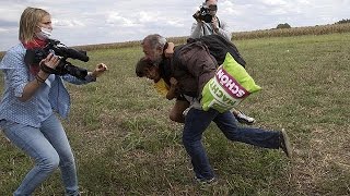 Hungarian camera woman caught on video kicking and tripping migrants