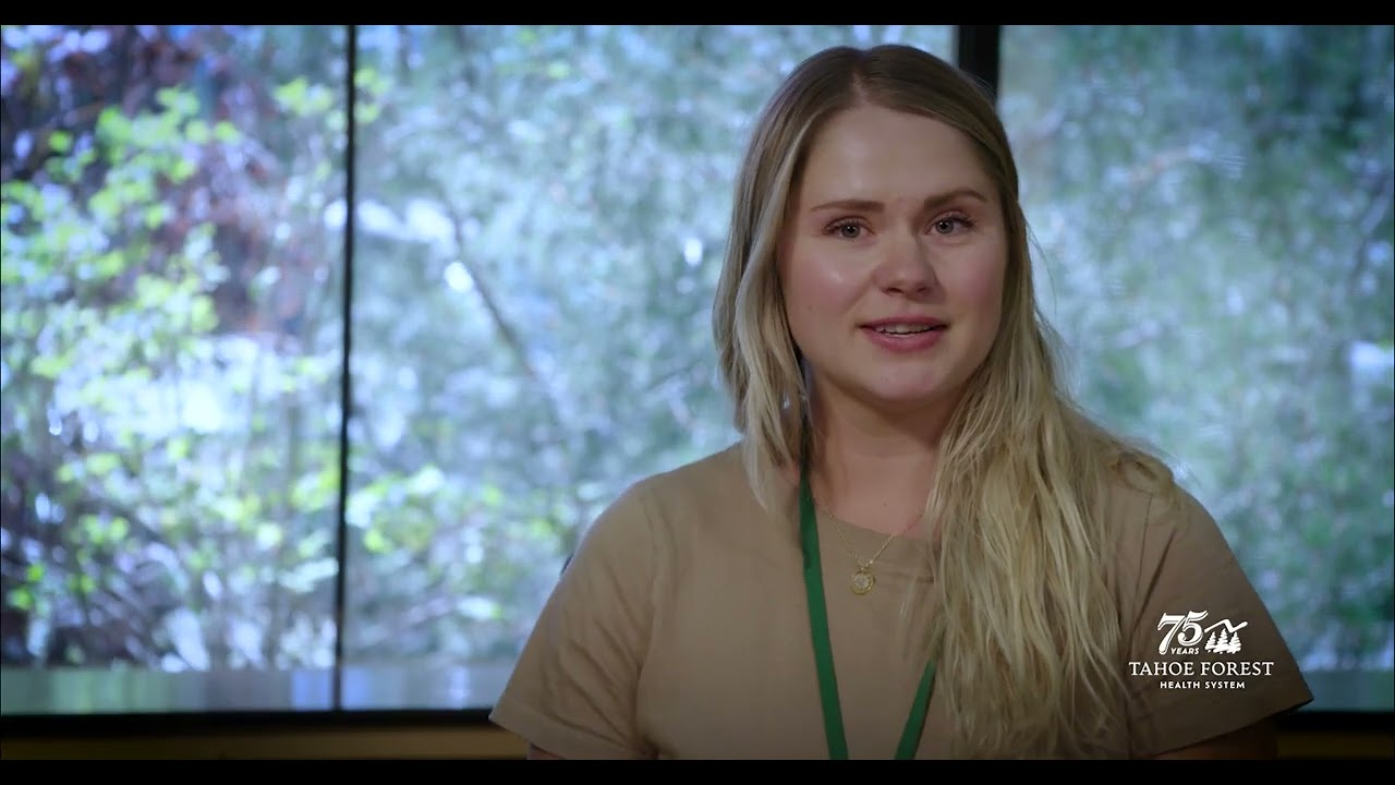 Justine Nelson, Integrative Wellness Coach at Tahoe Forest Hospital, sitting in front of a window