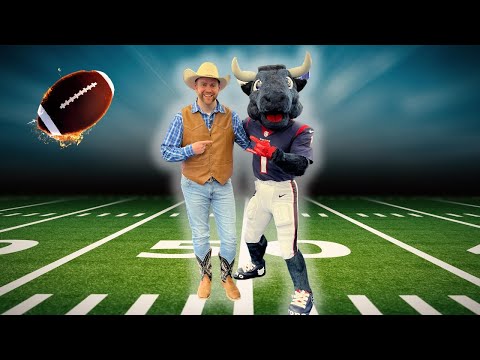 Man in a cowboy outfit posing with a football mascot on a football field; a football flies in from the left.
