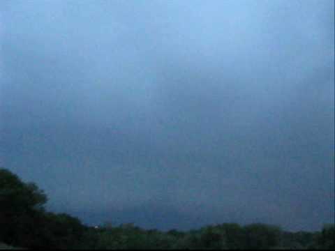 Supercell thunderstorm approacing and the evolution of the storm with lightning.