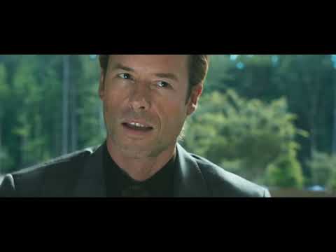 Trailer frame: the Malibu cliffside home under fire; the score shoulders the sequence while promo songs stay off-screen