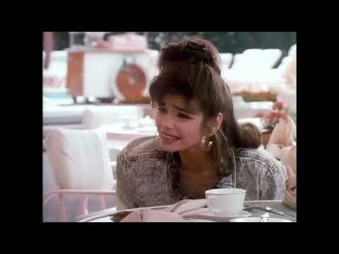 Shopping montage energy: hat boxes, mirrors, and a title song that struts