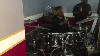 Lady June Pace Martin playing drums.