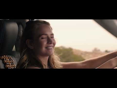 Trailer montage echoing the film’s road-trip grammar: buses, diners, desert highways, and sky balloons