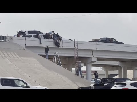 One Sheriff deputy dangling from an overpass after a crash on I-27 in Lubbock, Texas
