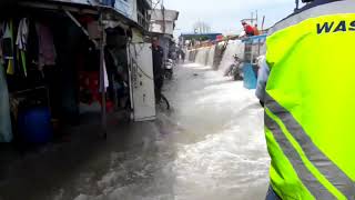 Overtopping wave at coastal dike in Pluit