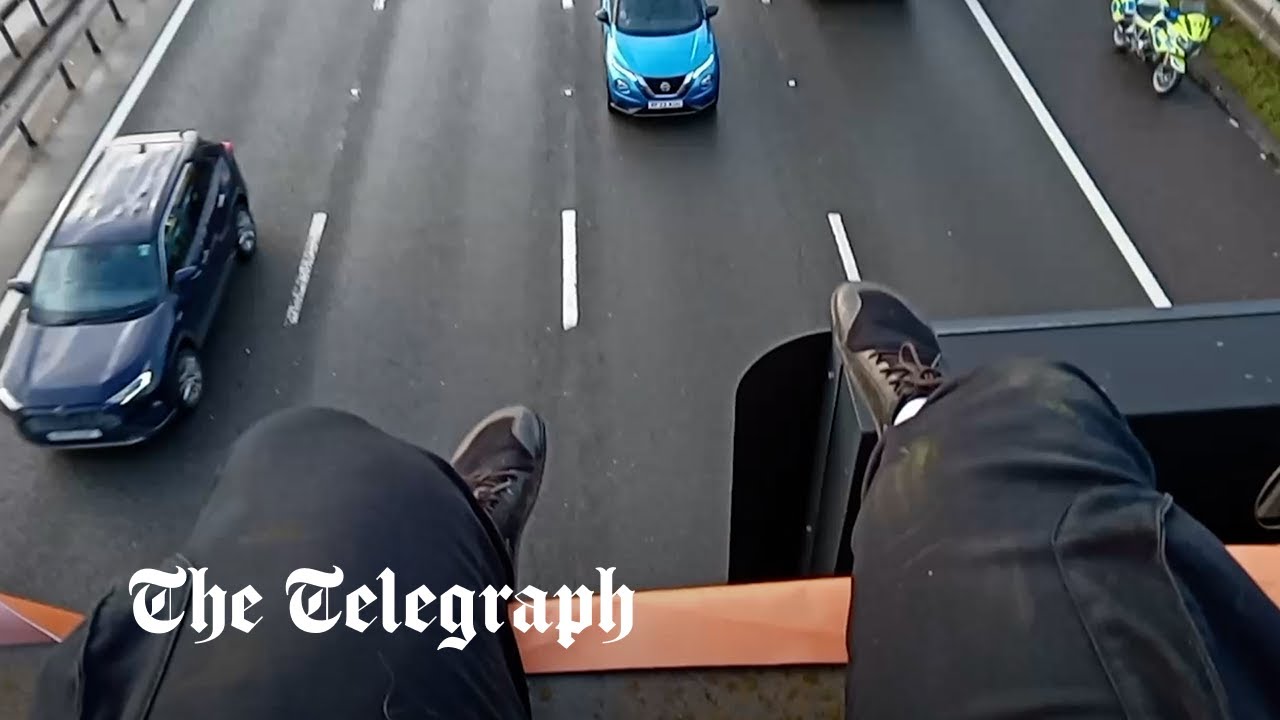 Watch: Former civil servant 'scared of heights' despite hanging from M25 gantry in Just Stop Oil protest - Vimarsana News