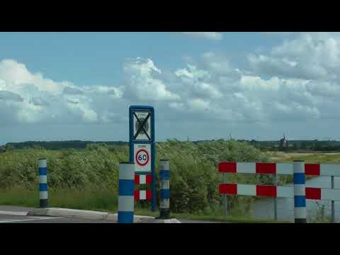 Dutch streets, road signs and cars at Kinderdijk historic windmill site in the Netherlands