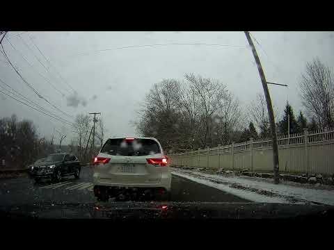 Snowy drive along Post Road in Wayland, Massachusetts